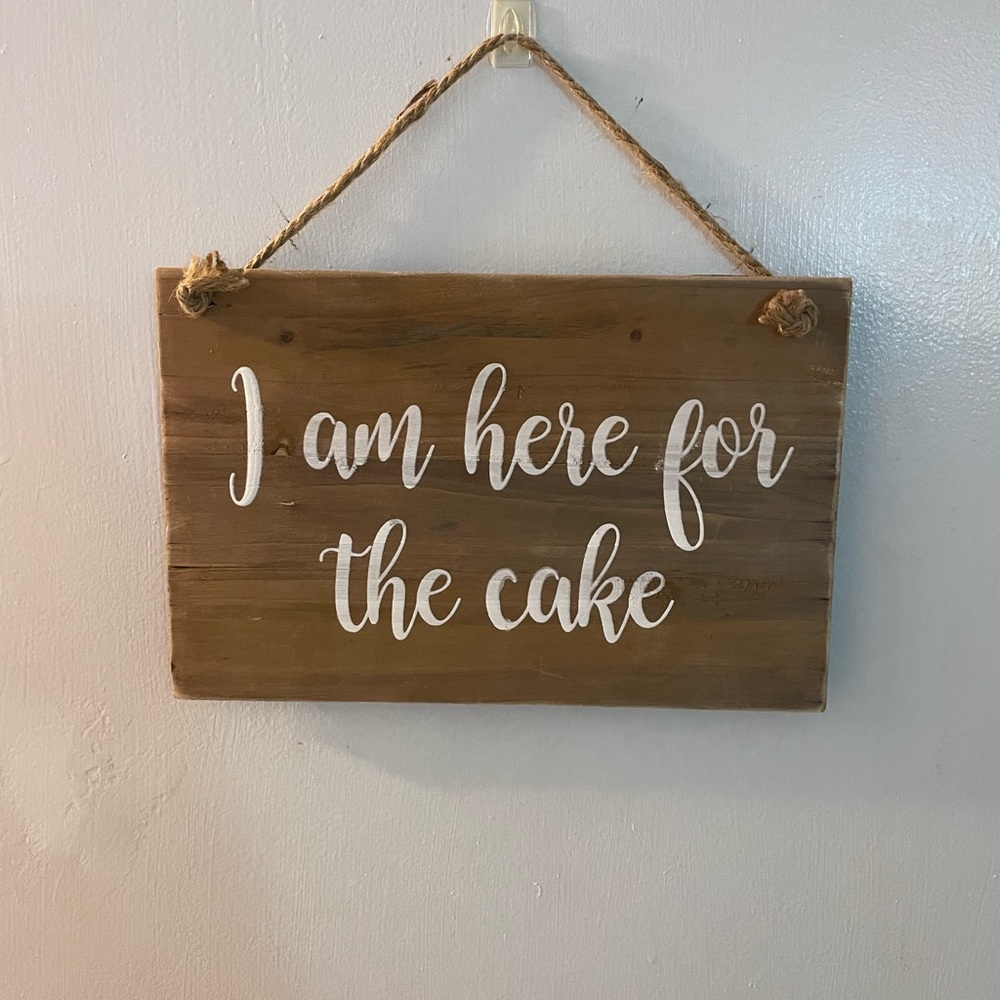 “I am here for the cake” wooden wall sign